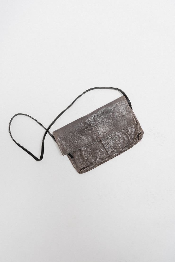 ISAAC SELLAM - Folded leather bag with signature staples