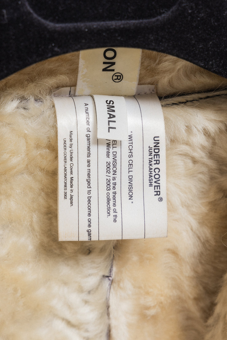 UNDERCOVER - FW02 “Witch’s cell division” Long shearling leather coat with waist straps and pocket detail