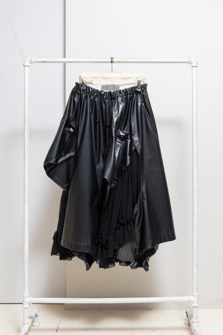 COMME DES GARÇONS - 2024 Faux leather skirt with volumes and cutouts showing off sheer underlayer