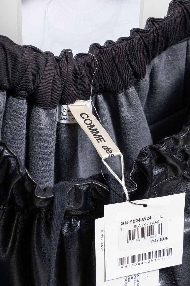 COMME DES GARÇONS - 2024 Faux leather skirt with volumes and cutouts showing off sheer underlayer