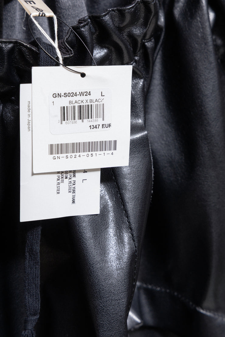 COMME DES GARÇONS - 2024 Faux leather skirt with volumes and cutouts showing off sheer underlayer