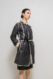 UNDERCOVER - FW02 “Witch’s cell division” Long shearling leather coat with waist straps and pocket detail