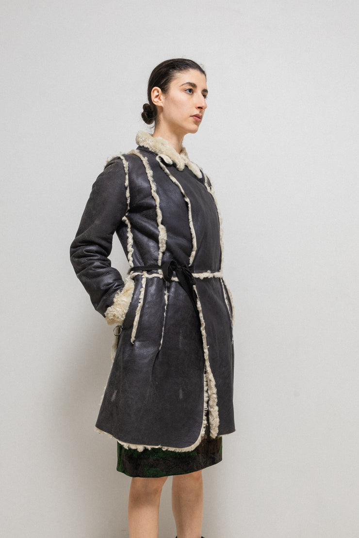 UNDERCOVER - FW02 “Witch’s cell division” Long shearling leather coat with waist straps and pocket detail