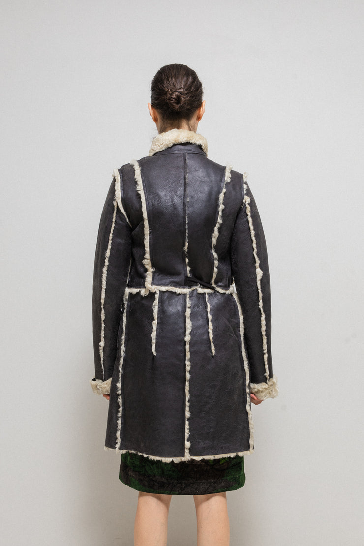 UNDERCOVER - FW02 “Witch’s cell division” Long shearling leather coat with waist straps and pocket detail