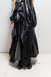 COMME DES GARÇONS - 2024 Faux leather skirt with volumes and cutouts showing off sheer underlayer